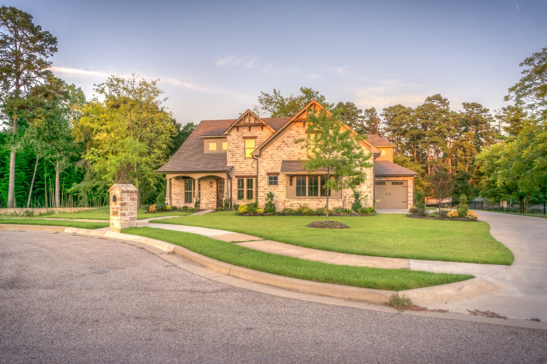 A stone house exterior lit in warm golden-hour light
